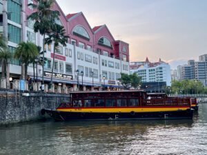 Singapore River in 2025 at Clarke Quay, with restored bumboats and shophouses, now restaurants and modern shops.